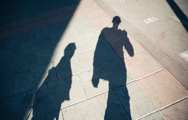 Shadows of people walking street Royalty Free Stock Photos