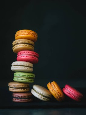 Colorful macaroons on stone background clipart