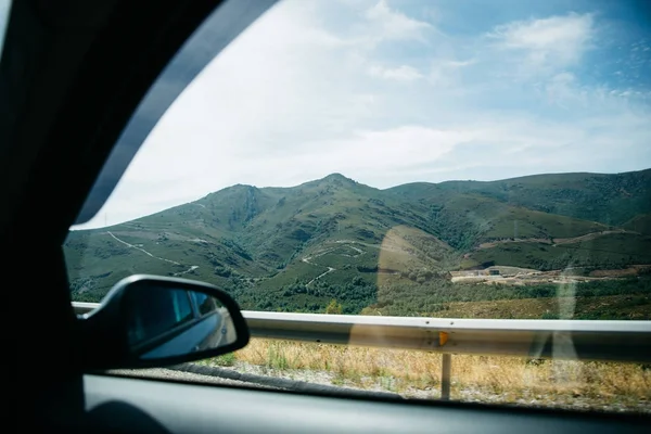 View from car window on green hills — Stock Photo, Image