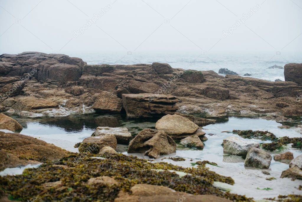Coastline landscape with big stones in fog