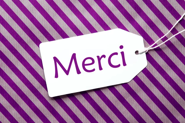 Label On Purple Wrapping Paper, Merci Means Thank You — Stock Photo, Image