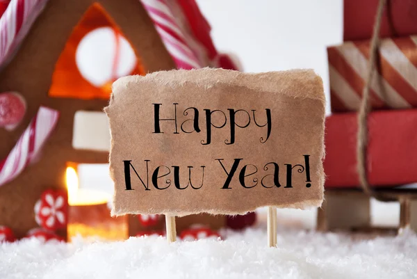 Perníková chaloupka s sáně, Text šťastný nový rok — Stock fotografie