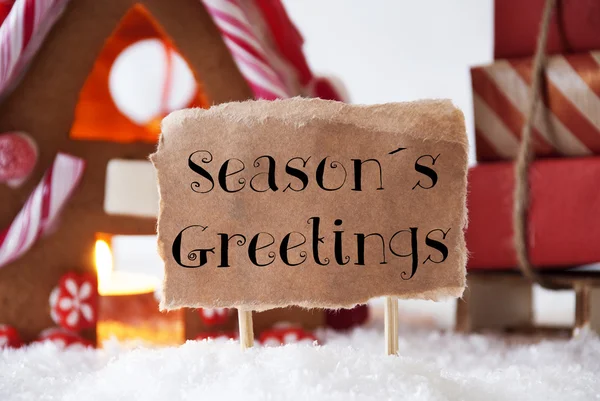 Pepparkakshus med släde, Text Seasons Greetings — Stockfoto