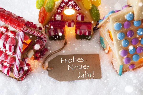 Casa de gengibre colorida, flocos de neve, Frohes Neues significa feliz ano novo — Fotografia de Stock