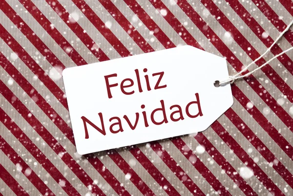 Etiket üzerindeki kırmızı kağıt, Feliz mutlu Noeller Navidad anlamına gelir, kar taneleri — Stok fotoğraf
