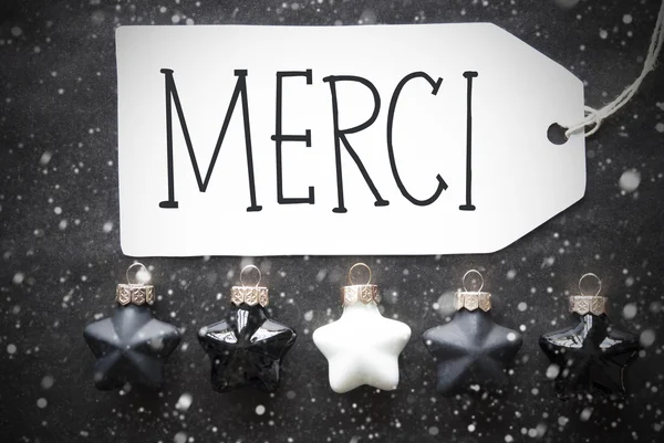Schwarze Weihnachtskugeln, Schneeflocken, merci bedeutet Danke — Stockfoto