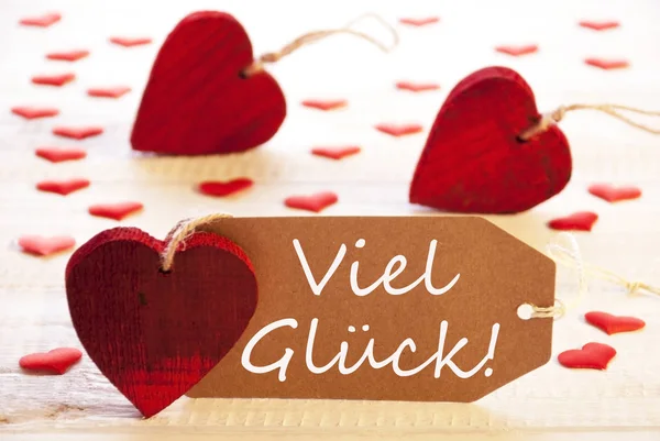 Çok kırmızı kalp, Viel Glueck anlamına gelir iyi şanslar etiketle — Stok fotoğraf