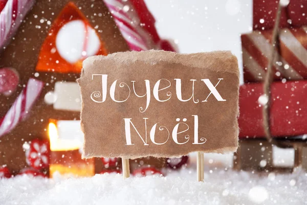 Μελόψωμο σπίτι με έλκηθρο, νιφάδες χιονιού, Joyeux Noel σημαίνει καλά Χριστούγεννα — Φωτογραφία Αρχείου