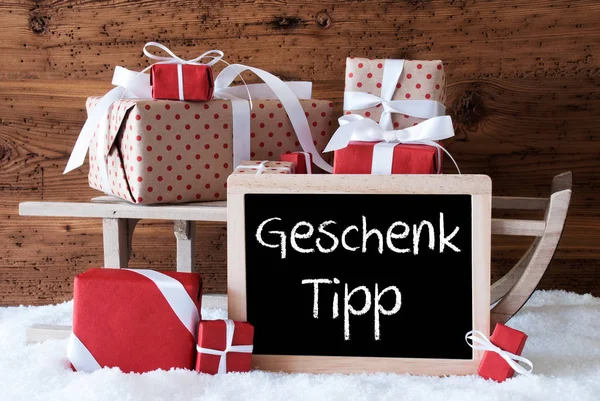 Traîneau avec des cadeaux sur la neige, Geschenk Tipp signifie Conseil cadeau — Photo