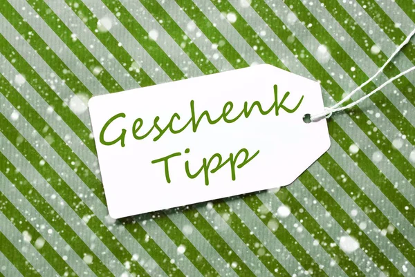 Étiquette, Papier d'emballage vert, Geschenk Tipp signifie conseil cadeau, Flocons de neige — Photo