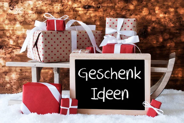 Traîneau avec cadeaux, neige, bokeh, Geschenk Ideen signifie idées cadeaux — Photo