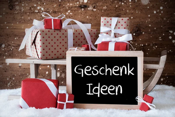 Traîneau avec cadeaux, neige, flocons de neige, Geschenk Ideen signifie idées cadeaux — Photo
