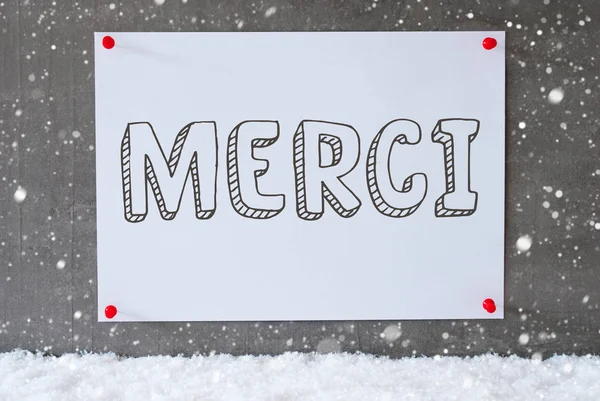 Etiqueta na parede de cimento, flocos de neve, Merci significa obrigado — Fotografia de Stock