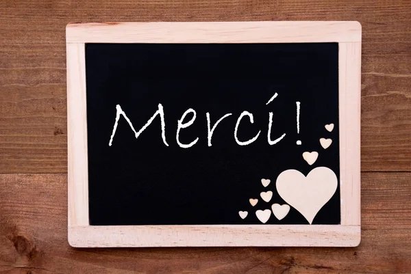 Blackboard With Wooden Hearts, Text Merci Means Thank You — Stock Photo, Image