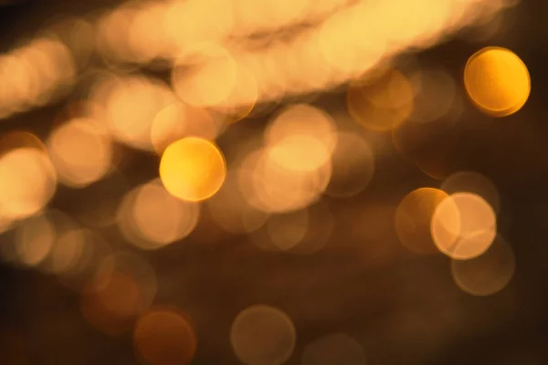 Bulanık bronz ışıklar arka plan, parti, kutlama veya Noel doku — Stok fotoğraf