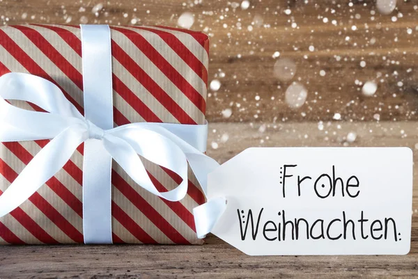 Рождественский подарок, этикетка, Frohe Weihnachten означает счастливого Рождества, снежинки — стоковое фото