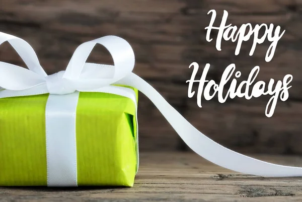 En grön gåva, White Bow, Trä bakgrund, Happy Holidays — Stockfoto