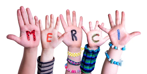 Crianças mãos construindo palavra Merci significa obrigado, fundo isolado — Fotografia de Stock
