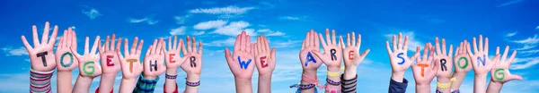 子供たちが手を携えて言葉を構築する私たちは強い、青い空 — ストック写真