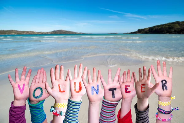 Children Hands Building Word Volunteer, Ocean Background — Stock fotografie