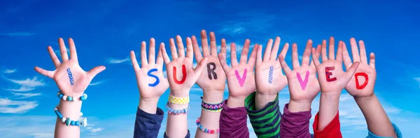 Children Hands Building Word I Survived, Blue Sky — Stock Photo, Image