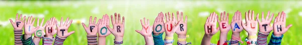 Дети руки построения Word Fight For Your Health, трава луг — стоковое фото