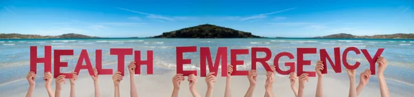 People Hands Holding Word Health Emergency, Ocean Background — Stock Photo, Image