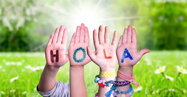 Kids Hands Holding Word Hola Means Hello, Grass Meadow — Stock Photo, Image