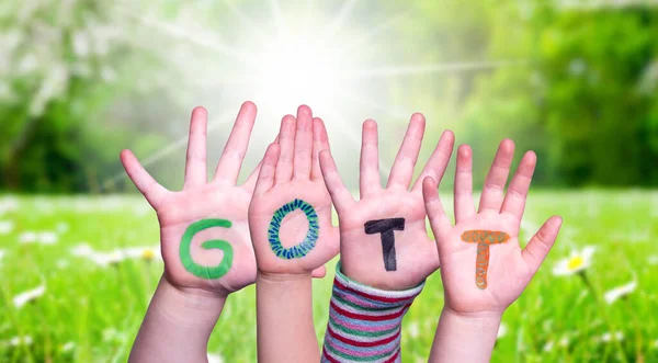 Barn händer bygga Word Gott innebär Gud, Gräs äng — Stockfoto