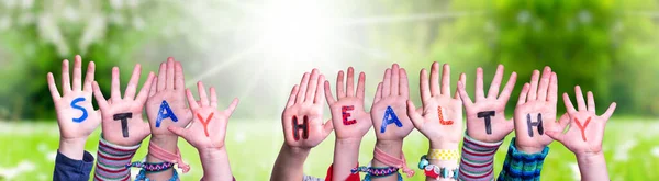 Kids Hands Holding Word Stay Healthy, Grass Meadow — Stock Photo, Image
