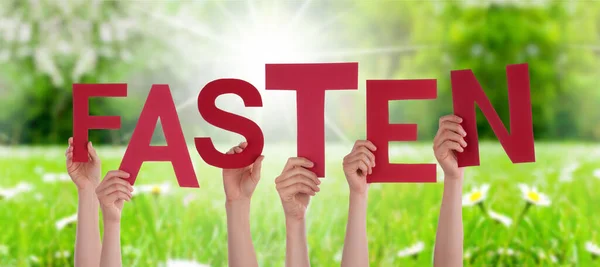 People Hands Holding Word Fasten Means Fasting, Grass Meadow — Stock Photo, Image