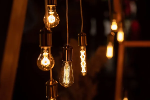 Burning an incandescent edison lamp with a large decorative spiral — Stock Photo, Image