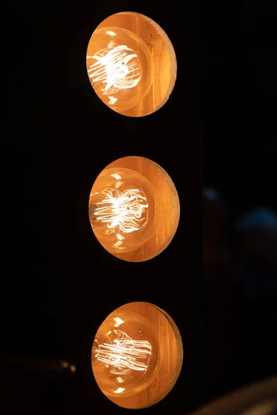 Burning an incandescent edison lamp with a large decorative spiral — Stock Photo, Image
