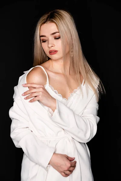 Närbild porträtt av vackra unga modell med blont hår och svarta kläder, poserar i fotostudio på mörk bakgrund — Stockfoto