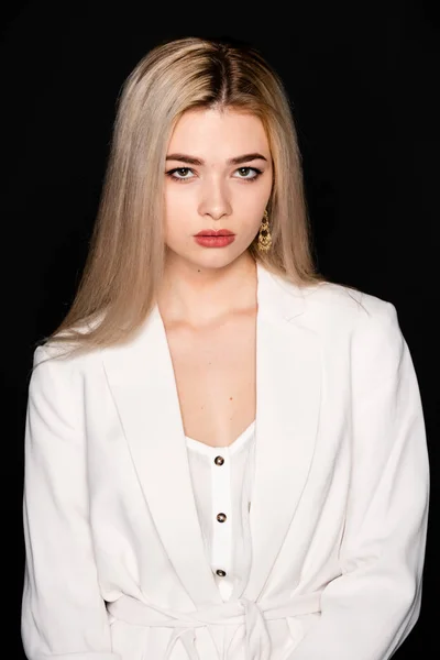 Close up portrait of beautiful young model with blonde hair and black clothes, posing in photostudio on dark background — Stock Photo, Image