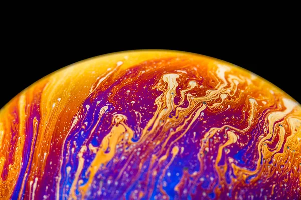 Rainbow soap bubble on an isolated black background. Close-up of the colorful surface. Poster blank — Stock Photo, Image