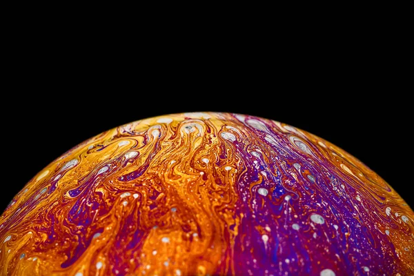 Rainbow soap bubble on an isolated black background. Close-up of the colorful surface. Poster blank — Stock Photo, Image