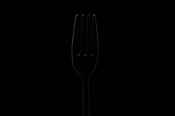 Silueta tenedor sobre fondo negro. Concepto —  Fotos de Stock