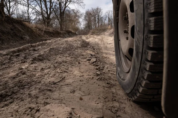 Bad country road. A dirt road damaged by the wheels of a heavy truck. Clay, dirt. Concept: problem with the roads; human impact on the environment.