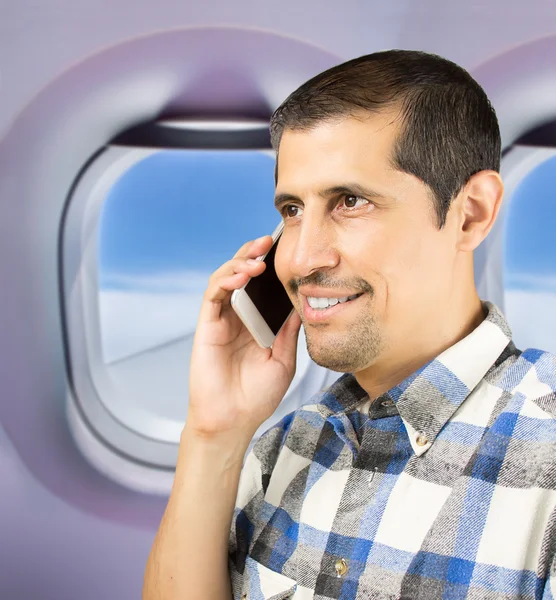 Calling cheerful by phone on the flight — Stock Photo, Image