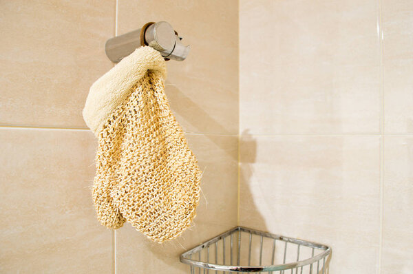 exfoliating mitt in the shower