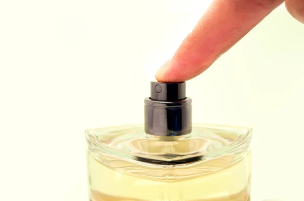 Pressing a bottle of cologne — Stock Photo, Image