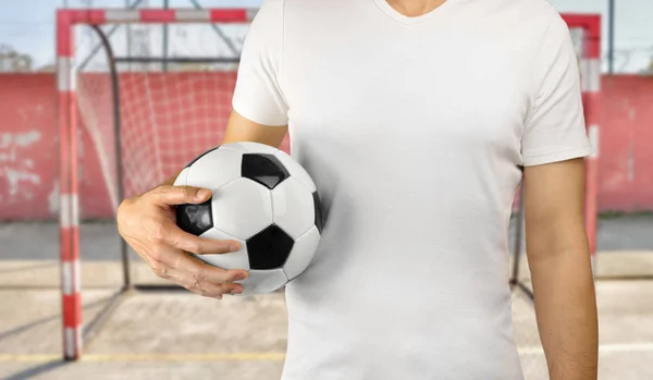 Deportista sosteniendo una pelota de fútbol — Foto de Stock