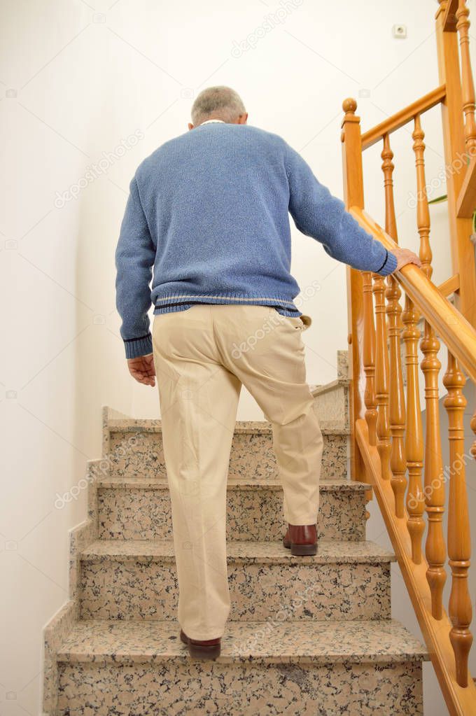 senior man climbing the upstairs