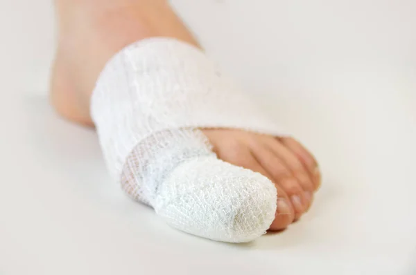 Injured toe with bandages — Stock Photo, Image