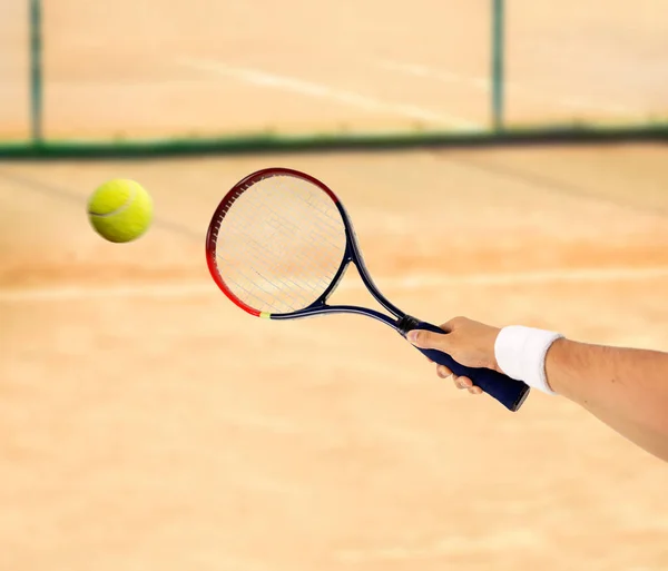 Hitting a tennis ball — Stock Photo, Image