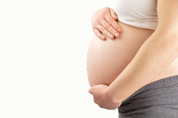 Woman holding her pregnant belly — Stock Photo, Image