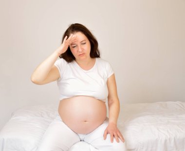 woman with pregnancy pains clipart
