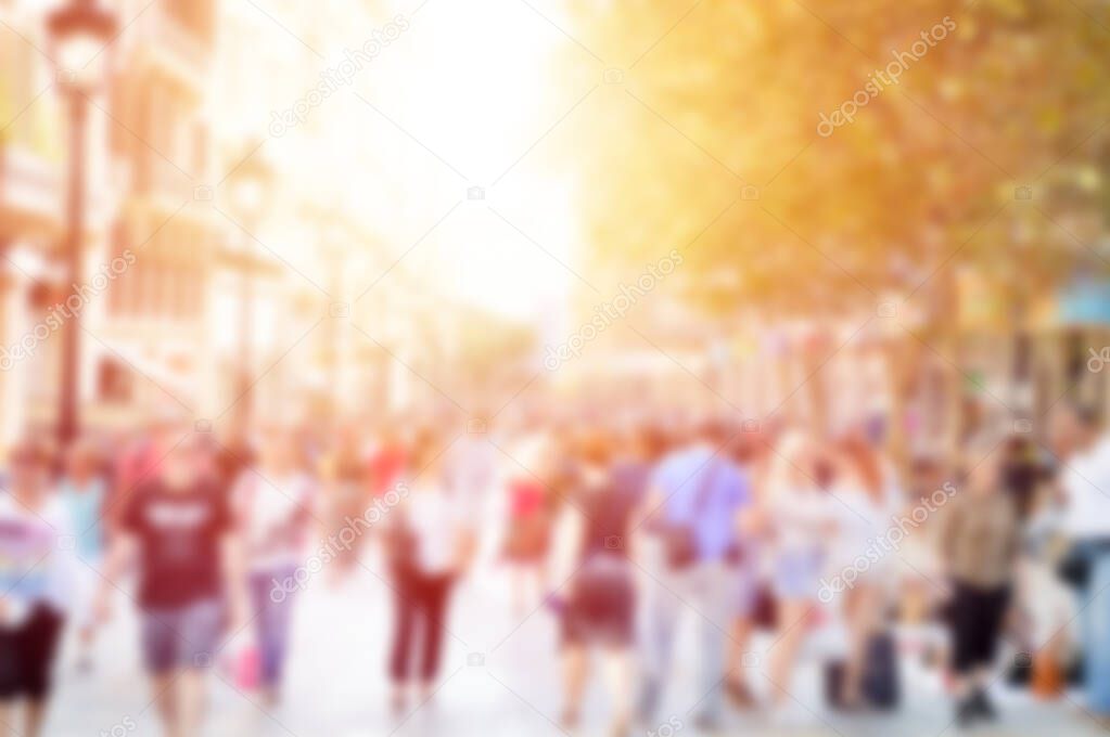 Blurred background. Blurred people walking through a city street