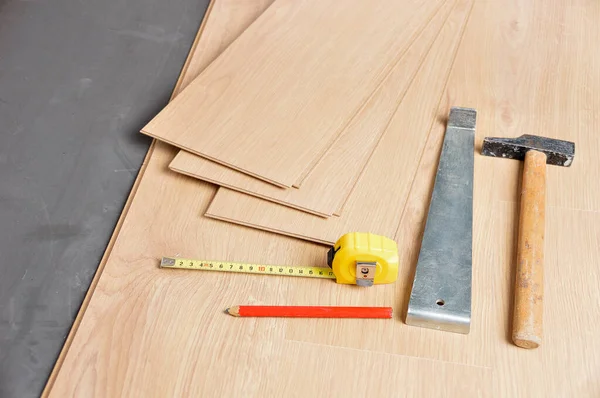 Planks of laminate floor and tools to install them